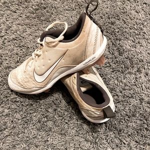 Nike softball cleats, color is white with rose gold bottom.